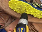 Drilling some holes in the yellow bottom of a swimrun shoe