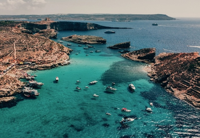 Comino Blue Lagoon from the air, with small bots at anchor.