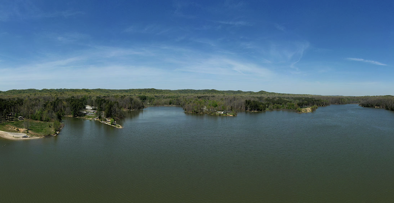 A view of Deam Lake, Indiana, on a sunny day with a blue sky