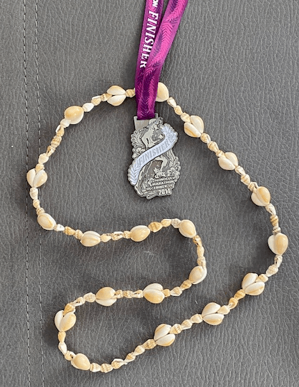 A Honolulu marathon finisher's medal with a shell lei A Honolulu marathon finisher's medal with a shell lei