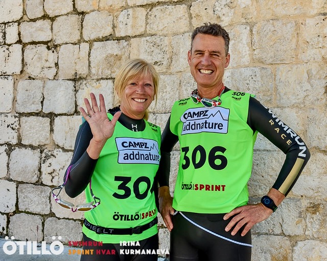 Two swimrun competitors wearing green tops before the start of the race Two swimrun competitors wearing green tops before the start of the race
