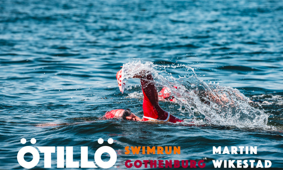 Otillo Gothenburg Action shot of a swimmer in an orange hat and red top, in the sea Otillo Gothenburg Action shot of a swimmer in an orange hat and red top, in the sea