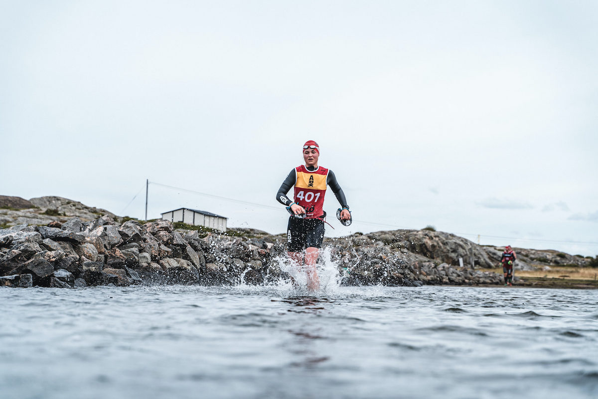 Otillo Gothenburg Action shot of a swimrunner running into the sea.