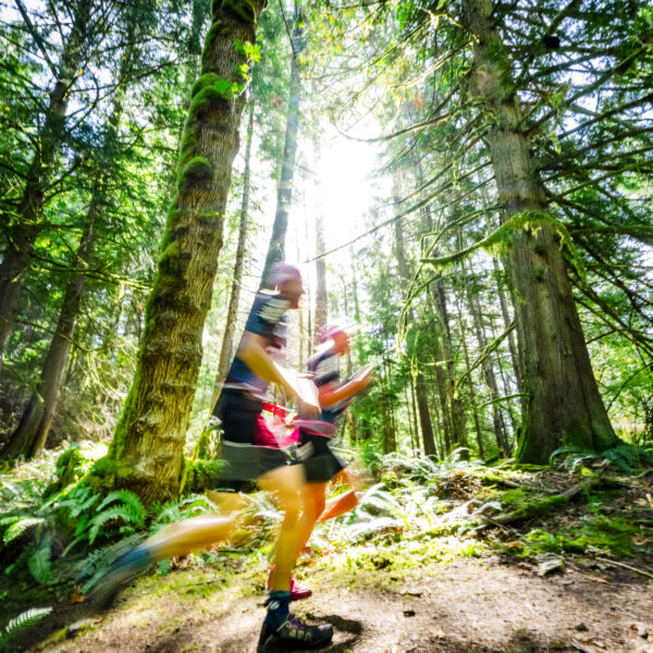 Otillo swimrun Orcas Island athletes running through woodland