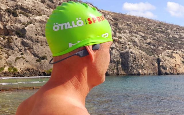 Richard in a green swimcap with the Nank bone conduction headphones