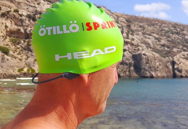Richard in a green swimcap with the Nank bone conduction headphones