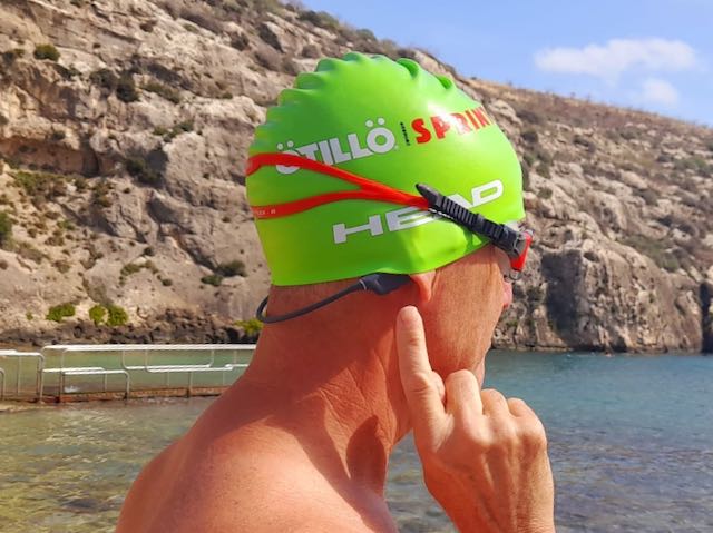Richard in a green swimcap with the Nank bone conduction headphones