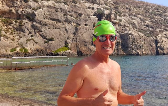 Richard in a green swimcap with the Nank bone conduction headphones