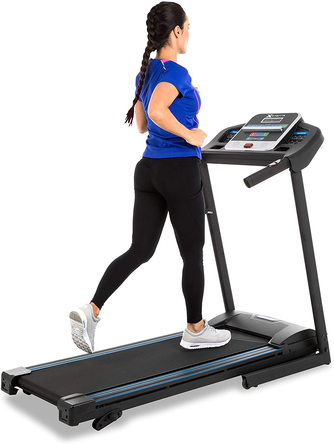 A woman in a blue top and black jogging pants running on a treadmill