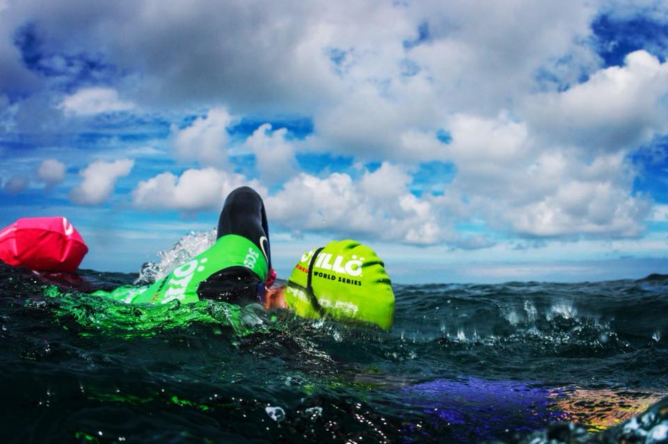 otillo swimmer in green cap swimming in the sea otillo swimmer in green cap swimming in the sea