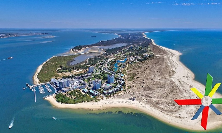 Troia peninsula in Portugal from the air on a sunny day, with blue waters on either side Troia peninsula in Portugal from the air on a sunny day, with blue waters on either side